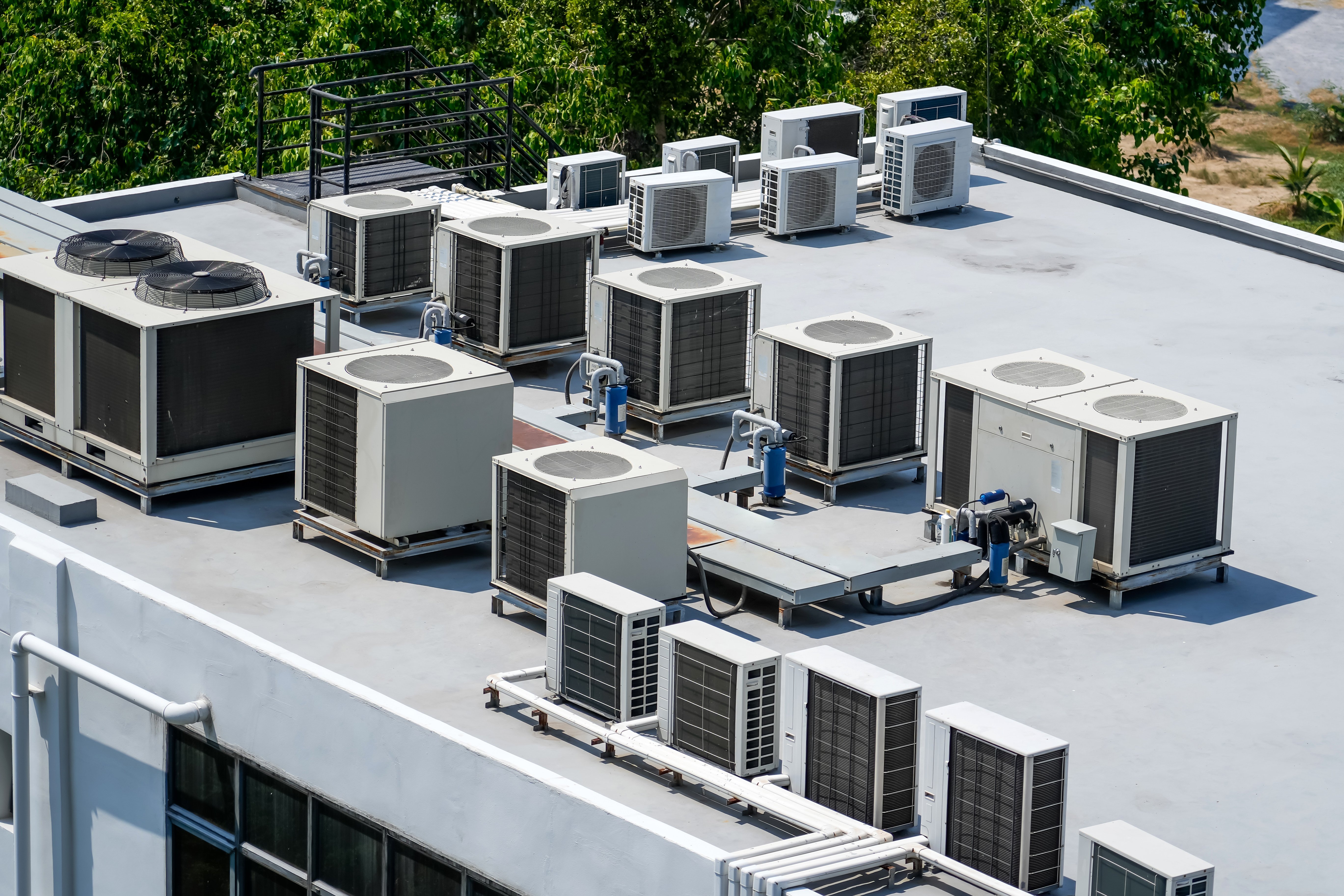 commercial hvac units sitting on top of a building on a nice day
